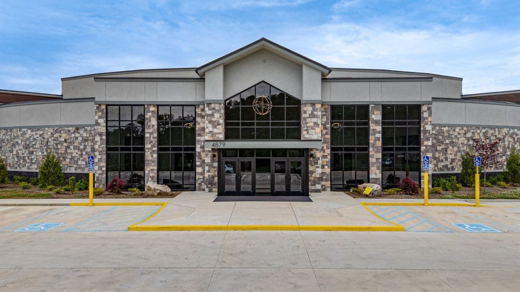 Commercial building exterior with stone facade and glass entrance — W Rondon Construction